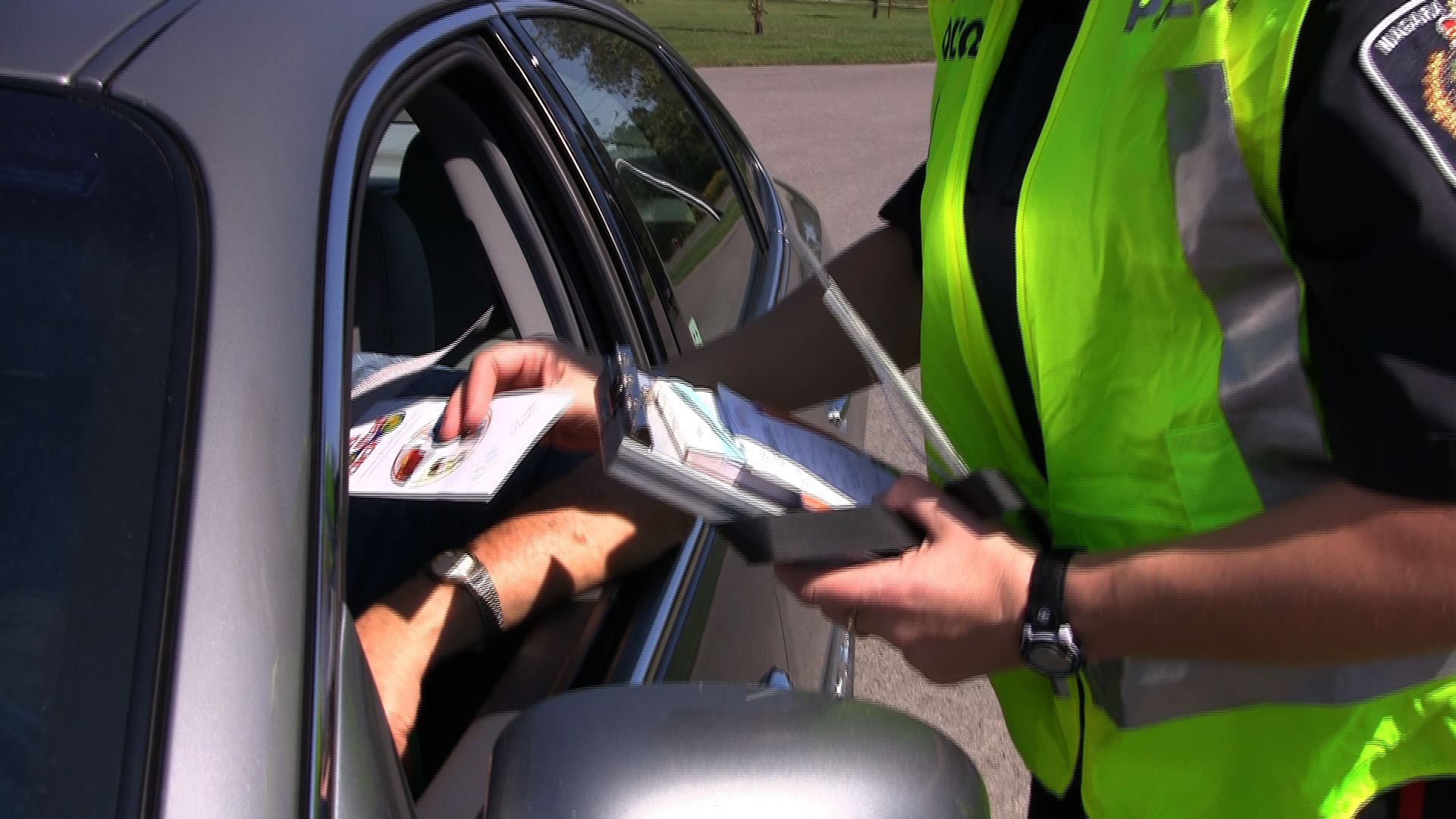 Officer giving motorist a traffic ticket